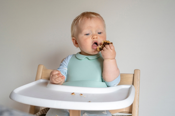 Baby eating in a high chair